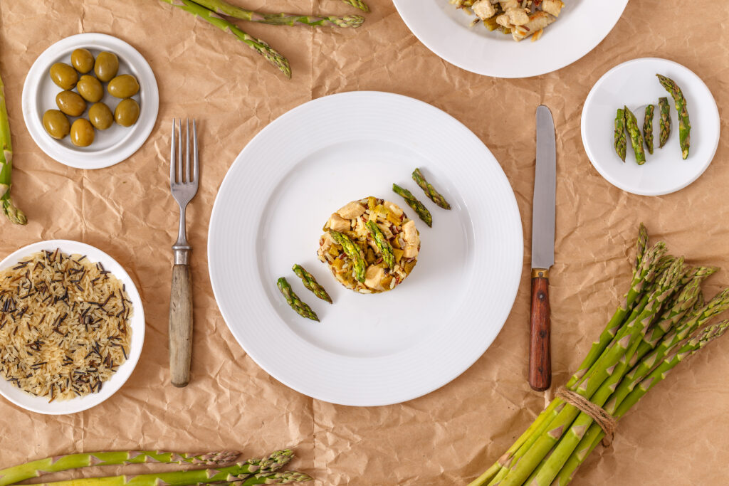 Dish of risotto with asparagus and chicken breast meat